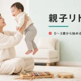 乳児を持ち上げて笑顔で見つめ合う母親と幼児